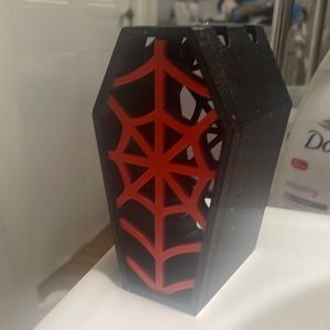 3D printed red and black spiderweb toothbrush holder